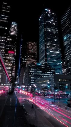 the city is lit up at night with long exposure