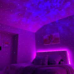 a bedroom with purple lighting and stars on the ceiling