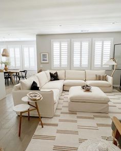 a living room filled with furniture and lots of windows