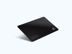 a black mouse pad sitting on top of a white surface