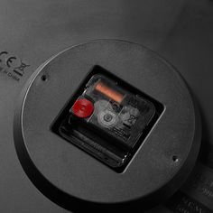 an electronic device with a red button on it