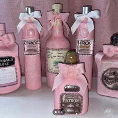 pink bottles with bows and labels on them