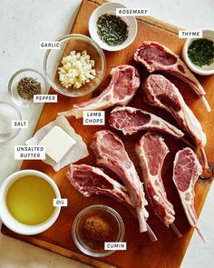 raw meats are laid out on a cutting board with spices and seasonings around them