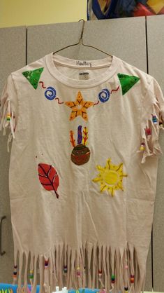 a t - shirt that has been decorated with colorful images and fringes on it