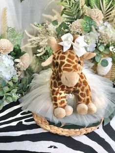 a stuffed giraffe sitting on top of a basket