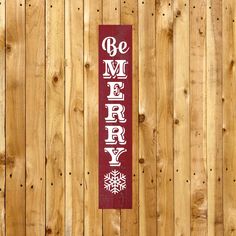 a wooden fence with a sign that says be merry