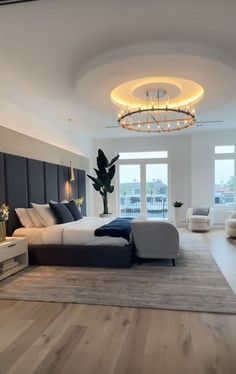 a large bedroom with white walls and wooden floors