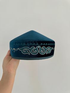 This stunning Kazakh & Kyrgyz headdress is a traditional piece of clothing worn in Central Asia, particularly in Kazakhstan and Kyrgyzstan. It is an important part of the region's cultural heritage, and has been worn by women for centuries. Made with high-quality materials and featuring intricate embroidery and beadwork, this headdress is a true work of art. The design is inspired by the Silk Road, the ancient trade route that connected China to the Mediterranean. The headdress is adorned with c Traditional Blue Cap, Traditional Adjustable Festival Turban, Traditional Adjustable Turban For Festivals, Adjustable Traditional Turban For Festivals, Traditional Adjustable Headpiece With Tall Crown, Traditional Headpiece With Tall Crown And Adjustable Fit, Traditional Blue Hat For Festival, Traditional Blue Festival Hats, Traditional Handmade Costume Hat With Round Crown