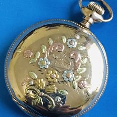 Antique 1912 Elgin Illinois 0s 14k Gold Inlay & Goldfilled Pocket Watch Runs With Solid 14k Gold Inlay Only The Rose And Green Inlay That You See In The Picture Is Gold The Rest Of The Watch Case Is Goldfield Hunting Pocket Watch Measurement 46mm X 36mm , Movement No 16741943 The Mineral Crystal Looks Fine Case Of The Watch Looks Good Some Scratches And Nicks Are Visible The Porcelain Dial Some Hair Lines As Shown In Pictures . The Watch Winds And Runs This Is Warranted 14fk Watch Case 25 Year Guarantee I Haven’t Done Any Service Or Repairs In This Watch Elegant Engraved Yellow Gold Pocket Watch, Elegant Yellow Gold Pocket Watch For Anniversary, Heirloom Yellow Gold Pocket Watch For Anniversary, Heirloom Yellow Gold Pocket Watch For Wedding, Yellow Gold Chronometer Jewelry Gift, Yellow Gold Chronometer Jewelry For Gift, Elegant Gold Hallmarked Pocket Watch, Yellow Gold Jewelry Chronometer For Gift, Yellow Gold Jewelry With Chronometer As A Gift