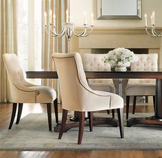 a dining room table with chairs and a chandelier