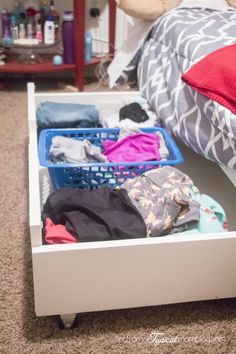 an under bed rolling storage drawer with clothes in it and the words diy under bed rolling storage drawers