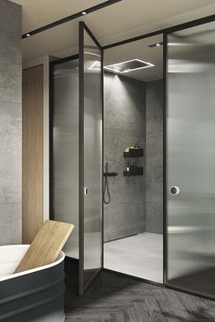 a bathroom with a glass shower door next to a bathtub