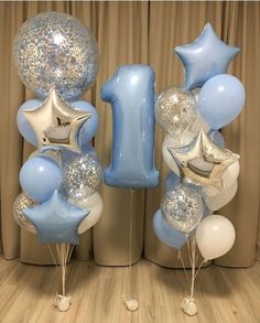 blue and white balloons are in the shape of numbers