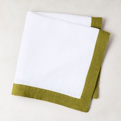 two green and white napkins sitting on top of each other