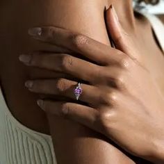 a close up of a woman's breast with a ring on her left hand