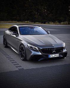 the front end of a silver mercedes s - class coupe parked in a parking lot