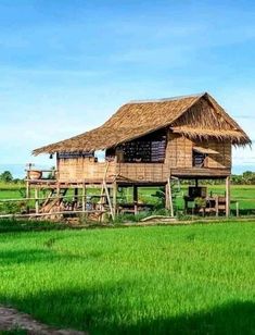 an old house in the middle of a green field