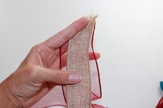 a person holding up a piece of fabric