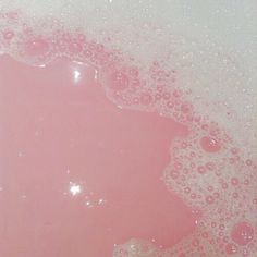 the bubbles in the water are pink and white