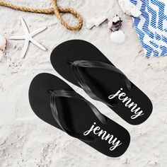 two pairs of personalized flip flops on the beach