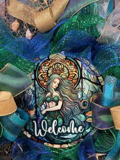 a wreath with a mermaid and the words welcome on it