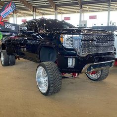 a large black truck parked in a garage