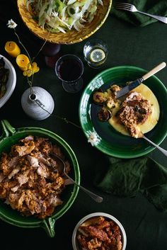 a table topped with plates and bowls filled with food