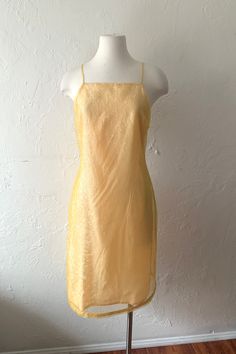 Lovin this 90s or 00s Y2K dress by Isabel Ardee. So so cute and special.. buttercup yellow sheer kind of iridescent crinkly shiny texture sheath dress with spaghetti straps. Zips up the back, lined and nice ribbon detail at hem.   Size 6, bust 36" waist 31" hip 39" length 41" Would be super cute hemmed mini mini too..  *a bit on me I'm usually an xs 0-ish so I'm holding a couple inches in at the back for front photo.. the mannequin is bust 34" waist 24" hip 34" so best on a small-ish / medium 4/6 Yellow Fitted Midi Slip Dress, Fitted Yellow Slip Dress Midi Length, Yellow Fitted Slip Dress For Evening, Fitted Yellow Slip Dress For Evening, Fitted Yellow Slip Dress For Night Out, Yellow Midi Length Slip Dress For Party, Yellow Fitted Slip Dress For Party, Vintage Spring Slip Dress For Party, Vintage Slip Dress For Spring Party