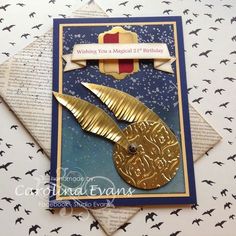 a close up of a greeting card with a gold bird on it's back