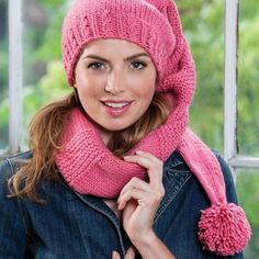 a woman wearing a pink knitted hat and scarf