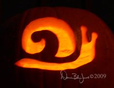 a carved pumpkin with the letter j on it's face and swirly tail