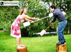 two people are playing with jugs in the grass and one person is on a stump