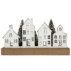 three white houses with trees in the front and one on the back, sitting on a cardboard box