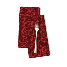 two red napkins with silverware on them