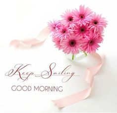 pink daisies in a vase with ribbon saying keep smiling good morning on white background