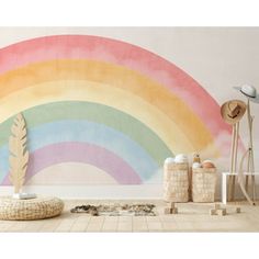 a rainbow painted on the wall in a living room with furniture and accessories around it