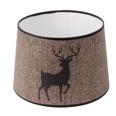 a lampshade with a deer silhouette on the side and black trim around it