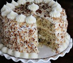 a cake with white frosting and coconut on top