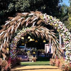 an archway decorated with flowers and palm trees