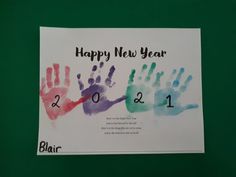 a happy new year card with handprints on the front and numbers on the back