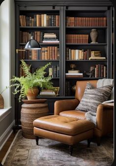 a chair and ottoman in front of a bookshelf filled with lots of books