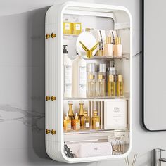 an open medicine cabinet in the corner of a white bathroom with gold handles and knobs