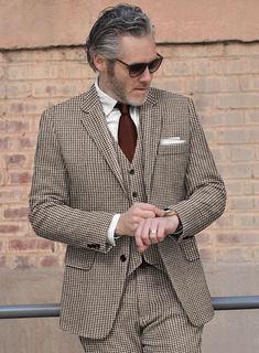 For your most important event, you demand excellent attire to make the occasion far more supreme. Crafted with wool, our Houndstooth Brown Tweed Suit is designed with a houndstooth pattern that looks like small broken squares and brown color will capture your perfect depiction to the world and it also gives comfort at every wear. So grab this very elegant suit that will make you look lavish on your day.  Look Includes   Houndstooth Brown Tweed Fabric  Two Button Jacket Style  Notch Lapel  Horn Brown Buttons  Single Vent  Three Cuff Buttons  Two Welted Back Pockets on Trousers    Click 'Customize Now' to modify the look if needed.   Lining: Viscose; Dry Clean. Tailored Tweed Blazer With Houndstooth Pattern, Tweed Jacket With Houndstooth Pattern For Business Casual, Classic Tweed Three-piece Suit For Semi-formal Occasions, Tweed Blazer With Houndstooth Pattern, Tweed Houndstooth Blazer With Notch Lapel, Tailored Semi-formal Blazer With Houndstooth Pattern, Tailored Houndstooth Blazer For Semi-formal Occasions, Tailored Semi-formal Houndstooth Blazer, Tailored Houndstooth Suit For Fall