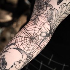 a person with a spider web tattoo on their arm