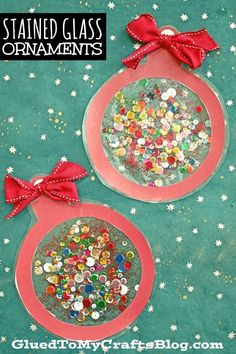 two christmas ornaments made out of glass with red bows on them and glitter in the middle