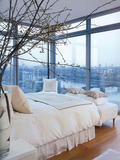 a bedroom with a large window overlooking the city