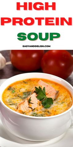 a white bowl filled with soup and garnished with parsley next to tomatoes