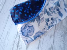 Bright blue floral zipper pouch measures 8.5×6.5. Made of 100% quality cotton with coordinated fabric lining. Attached matching Tassel in cobalt blue.  Great gift for graduations, birthdays, hostess gift and makes a great get well gift  Used to carry your make up, planner supplies, charger and earbuds. Loose change or anything else that falls to the bottom of your purse! Spot clean or hand wash. Lay flat to dry. Accessories not included. Blue Zipper Pouch Cosmetic Bag Gift, Blue Cotton Bags With Zipper Pouch, Blue Cotton Bag With Zipper Pouch, Blue Bag With Zipper Pouch As Gift, Period Pouch, Loose Change, Get Well Gifts, Planner Supplies, Blue Makeup