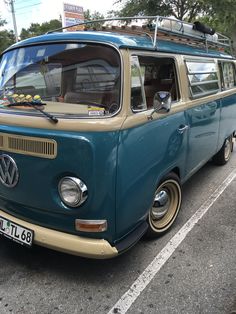 an old vw bus parked in a parking lot