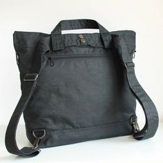 "Black Multi Way Waxed Canvas Backpack MATERIALS Exterior fabric: 100% black waxed cotton canvas (British) Lining fabric: 100% cotton twill (Italian) APPROXIMATE DIMENSIONS Width: 35cm / 13.75\" Depth: 12.5cm / 5\" Height: 38cm / 15\" Shoulder strap length: adjustable from 96.5cm to 175cm / 38\" to 69\" Exterior zipper pocket at back: 26cm / 10.25\" W x 25cm /10\" H Interior sleeve pocket 1: 9cm /3.5\" W x 15cm / 6\" H x 2cm / 0.75\" D Interior sleeve pocket 2: 9.5cm /3.75\" W x 15cm / 6\" H x 2 Waxed Canvas Backpack, Canvas Rucksack, Custom Backpack, Backpack Material, Handmade Uk, Crossbody Messenger Bag, Canvas Backpack, Waxed Canvas, Everyday Bag